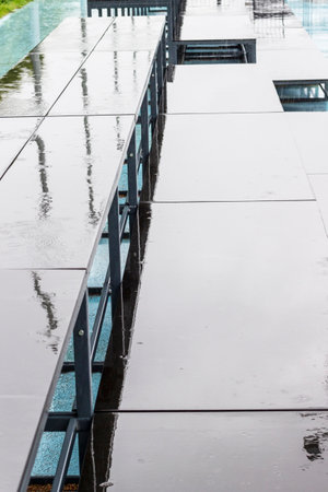 Abstract background. Stadium stand after rain. Reflections in puddles. Part of the frame.の写真素材