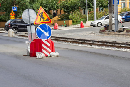 Road warning signs during road repairs. Motor vehicles on the road.