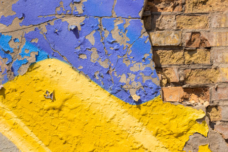 Blue and yellow old plaster on a brick wall. Abstract background.の写真素材