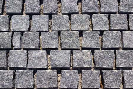 Paving the road with square granite stones.の写真素材