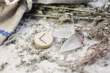 Scandinavian wooden rune Kenaz on linen