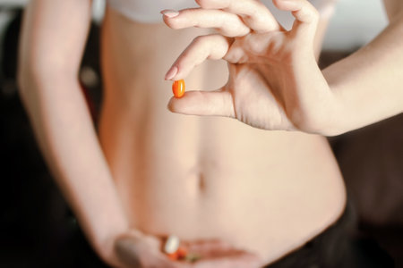Woman holding a medical tablet in front of her stomachの写真素材