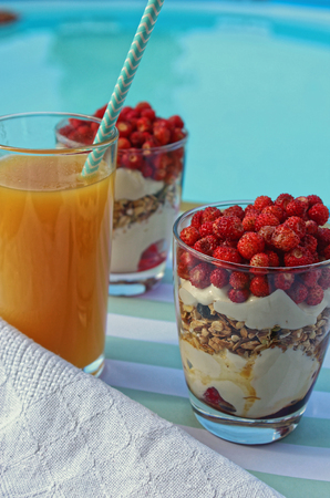 Mango juice and granola breakfast at the poolの写真素材