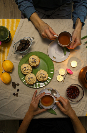 Two people have a lunch with tea and muffinsの写真素材