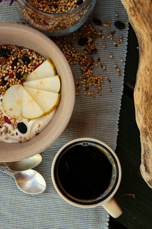 Healthy breakfast with coffee and granola and pearsの写真素材