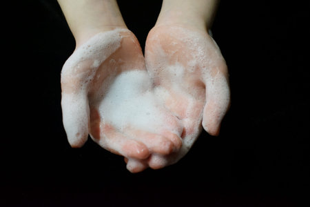 Hands in the foam. Wash with soap and waterの写真素材