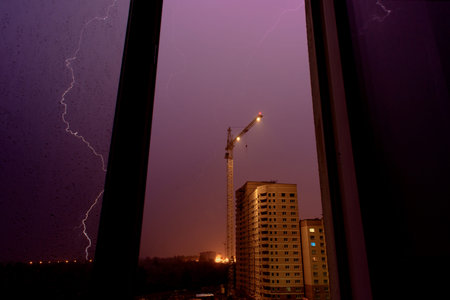 lightning on a building site, a thunderstorm view from the window