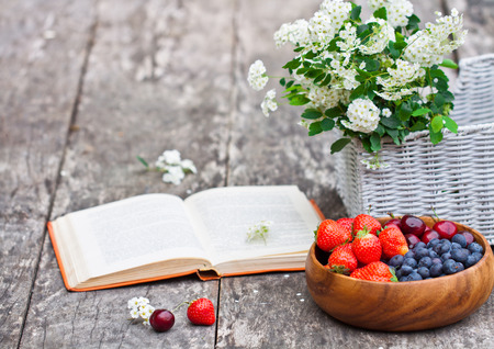 fresh berries white bouquet and open  bookの写真素材