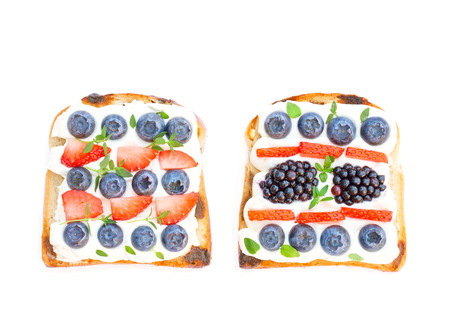 Slices  of bread with cream cheese berries and thyme isolated on whiteの写真素材