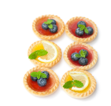 set  of tasty tartlets with lemon and raspberry jam isolatedの写真素材
