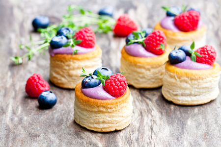 puff  pastry stuffed with soft blueberry curd with berries and thyme on rustic wooden backgroundの写真素材