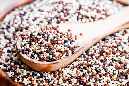 close  up of a wooden bowl with quinoa seeds on a old tableの写真素材