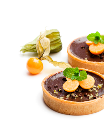 mini  chocolate tarts with fresh physalis isolated on white の写真素材