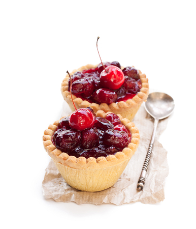 egg  custard tarts with cranberry jam isolated on white の写真素材