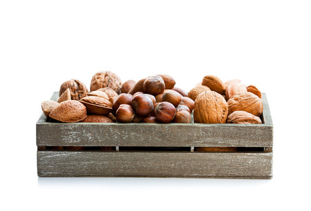 Various  nuts in wooden box isolated on white の写真素材