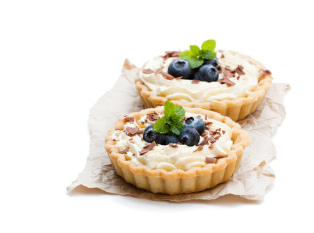Delicious  tarts with cream and fresh blueberry isolated on white の写真素材