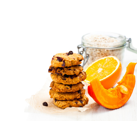 Homemade  pumpkin and orange cookies on white background の写真素材