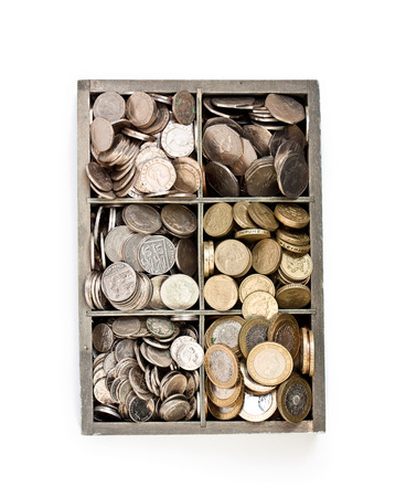 wooden  cashbox full of pound sterling coins の写真素材