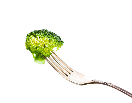sliced  fresh raw broccoli on vintage fork の写真素材