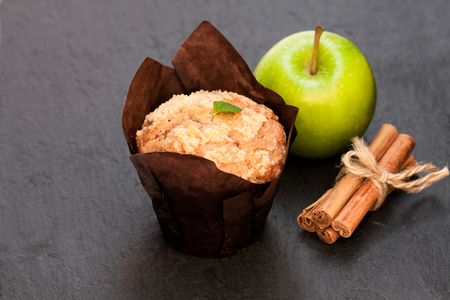 Apple  cinnamon muffins on black stone background の写真素材