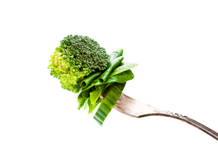 sliced  green vegetables on vintage fork の写真素材