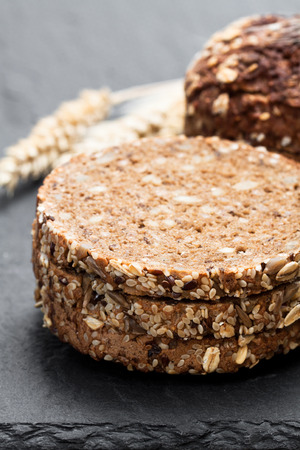Sliced  rye bread on black stone background の写真素材