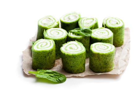 Rolled  spinach pancakes isolated on whiteの写真素材