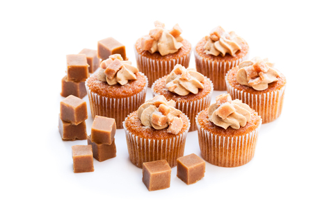 Toffee  cupcakes with white cream isolated on whiteの写真素材