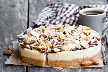 Almond  cheesecake with chocolate flakes on wooden tableの写真素材