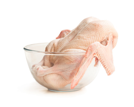 Raw whole  duck in clear glass bowl isolated on white background. Ready for cooking.の写真素材