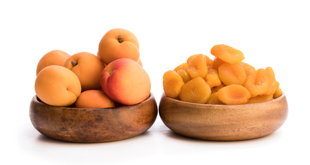 Fresh  and dried apricot in wooden bowlsの写真素材