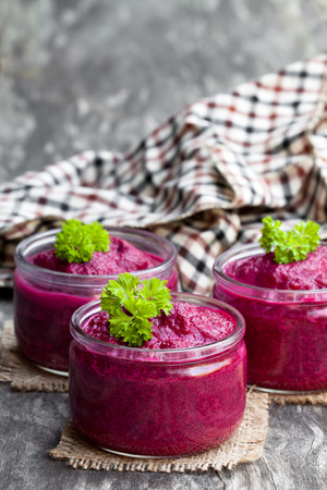 Beetroot  puree in glass jars on wooden tableの写真素材