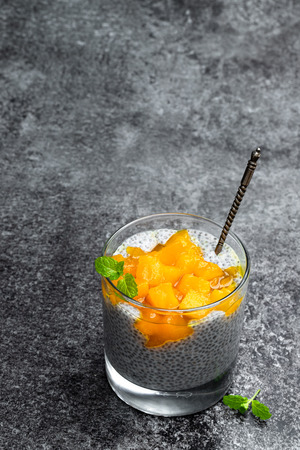 Chia  seed pudding with yellow jam on gray stone tableの写真素材