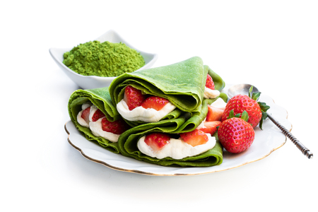 Matcha  green tea crepe with whipped cream and strawberry isolated on whiteの写真素材