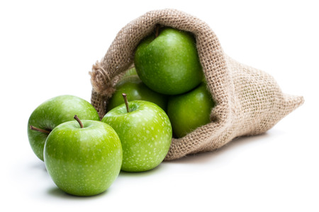 Ripe  green apples in sakcloth bag isolated on whiteの写真素材