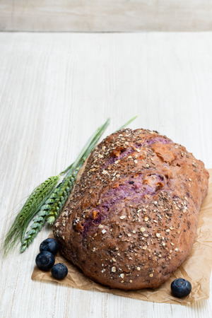 Blueberry  and chia seed bloomer on white wooden tableの写真素材