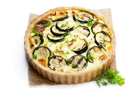 Homemade  courgette and feta quiche isolated on whiteの写真素材