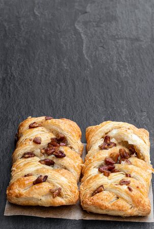 Flaky  pastry filled with maple syrup and topped with pecan isolated on white の写真素材