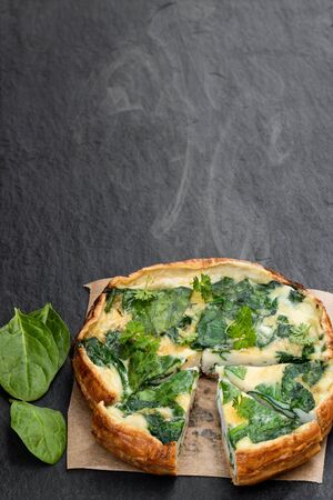 Omelette  with spinach on black stone background の写真素材