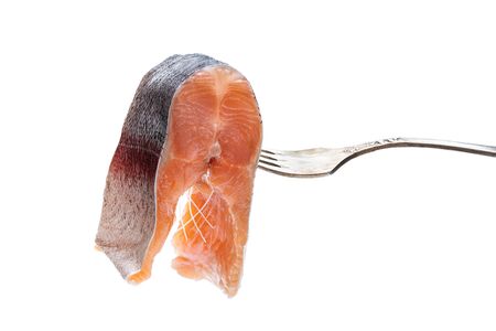 Salted  slice of  trout on a fork isolated on whiteの写真素材