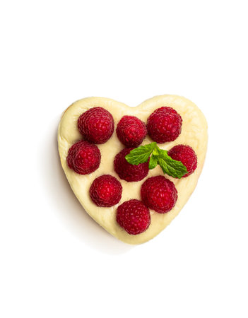 Heart  shaped cheesecake with raspberry isolated on white. Top view の写真素材