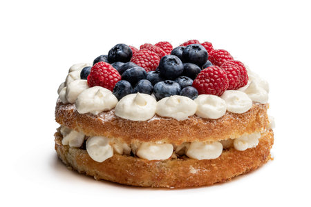 Victoria  sponge cake with whipped cream and berries on top isolated on white 