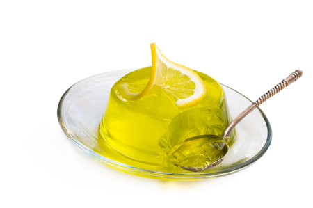 Lemon  jelly on glass saucer isolated on white 