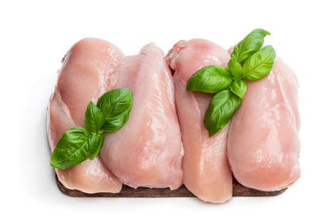 Fresh raw chicken breast on wooden board isolated on whiteの写真素材