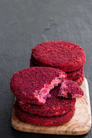 Vegan beetroot and bean burgers on wooden board isolated on whiteの写真素材