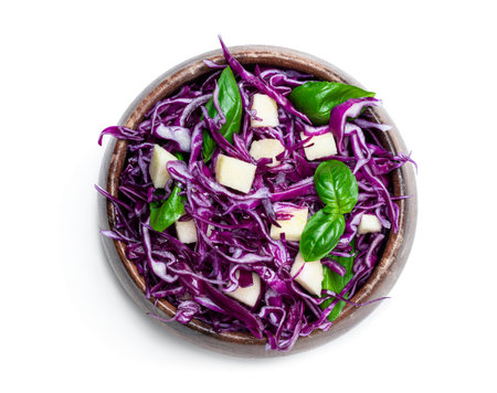 Vegetarian  salad with red cabbage and apple in wooden bowl isolated on white
