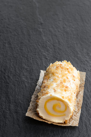 Full  fat soft cheese with pineapple and chopped almonds on black stone background