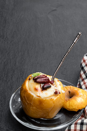Baked apples stuffed with soft cheese and nuts isolated on whiteの写真素材
