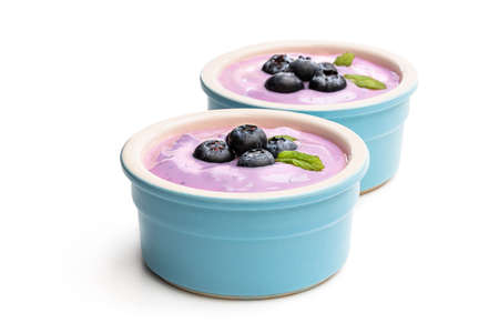 Fresh  yoghurt with blueberry in ceramic bowl isolated on whiteの写真素材