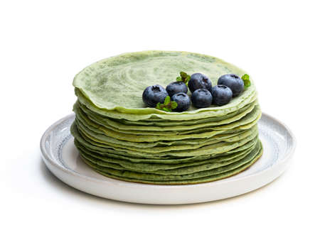 Green  pancakes in small pan isolated on whiteの写真素材